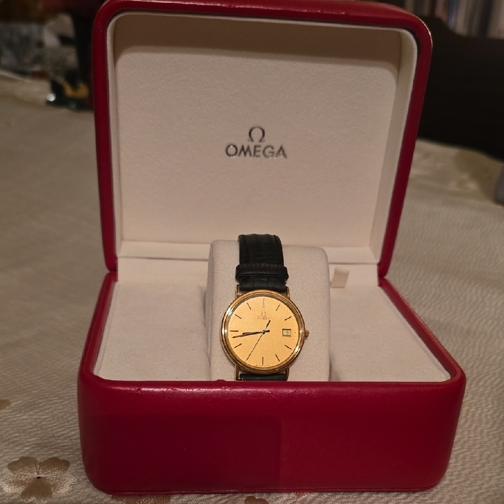 Omega Timepiece with Gold Dial and Black Leather Band